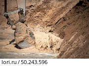 Excavator working with soil and water, during earthmoving works. Стоковое фото, агентство Ingram Publishing / Фотобанк Лори