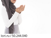 Young Adult Muslim Woman girl making Duas for Muslim god blessing prayer. Studio shot of woman isolated on white background. Стоковое фото, агентство Ingram Publishing / Фотобанк Лори