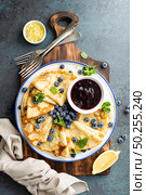 Crepes, thin pancakes with blueberry jam and fresh berries with lemon zest. Стоковое фото, агентство Ingram Publishing / Фотобанк Лори