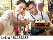 Selfie shit of two BLOGGER of young adult asian owner entrepreneur review cafe coffee shop for social media and online marketing in cafe. Using for startup of small business maketing and consumerism concept. . Стоковое фото, агентство Ingram Publishing / Фотобанк Лори