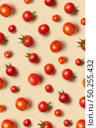 Freshly picked red ripe organic cherry tomatoes on a beige background. Top view. Vegetable vegan pattern.. Vegetable pattern with ripe fresh organic cherry tomatoes. Стоковое фото, агентство Ingram Publishing / Фотобанк Лори