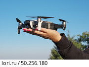 Drone landing on a woman hand palm. Element of design. Стоковое фото, агентство Ingram Publishing / Фотобанк Лори