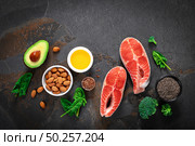 Omega-3 fats. Salmon fish and vegetarian sources of unsaturated fatty acids. Healthy food concept for good health. Top view. Стоковое фото, агентство Ingram Publishing / Фотобанк Лори