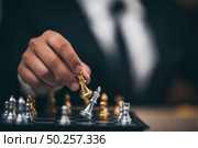 Close up shot golden chess to defeat killing silver king chess on white and black chess board for business challenge competition winner and loser concept, selective. Стоковое фото, агентство Ingram Publishing / Фотобанк Лори