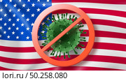 Forbbiden sign with crossed out Coronavirus molecule on the background of American flag. Rapid spread of Coronavirus, Covid 19 in the world. Global calamity. Quarantine concept.. Warning sign with crossed out Coronavirus bacteria on the background of American flag. Стоковое фото, агентство Ingram Publishing / Фотобанк Лори