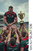 A heartwarming moment of a rugby team lifting their coach in celebration, their faces filled with joy, the trophy gleaming in the arms. first prize championship. Стоковое AI-видео, аниматор Sergey Grishin / Фотобанк Лори