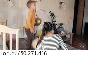 Fun Kids Celebration with Colorful Balloons, Party Horn Blowers and Festive Hats. Joyful Siblings Children Playful Little Girls and a Boy Dancing, Jumping, Playing among Golden Decorations. Party Time. Стоковое видео, видеограф Марина Демидюк / Фотобанк Лори