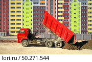 Building urban scene. Multistorey building apartment house and dump truck unload soil at day. Стоковое фото, агентство Ingram Publishing / Фотобанк Лори