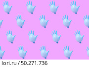 Creative pattern from blue rubber surgical gloves as flying balloons against a hot pink background.. Pattern from blue latex glove as balloons on hot pink background. Стоковое фото, агентство Ingram Publishing / Фотобанк Лори