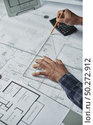 Hands of architect drawing blueprint of the house. Designing new house. Стоковое фото, агентство Ingram Publishing / Фотобанк Лори