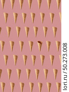 Decorative food pattern from floating crispy waffle cones for making fresh sweet ice-cream or desserts against peach pink background.. Flying crunchy waffle cones pattern for making sweet ice cream. Стоковое фото, агентство Ingram Publishing / Фотобанк Лори