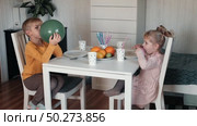 Children Drinking Juice on a Birthday Party at Home. Siblings, girls and a boy together celebrating a party, eating cake sitting at festive table. Little Kid Celebration. Surprise. Low key. Стоковое видео, видеограф Марина Демидюк / Фотобанк Лори