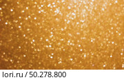 An abstract gold background with sparkle lights and bokeh. Useful as Christmas background or greeting card. Gold blurred light. Стоковое видео, видеограф Марина Демидюк / Фотобанк Лори