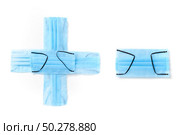 Symbol plus and minus handmade from medical antibacterial protective blue face masks on a white background, copy space. Creative typeface for making up new numerical information.. Sign plus and minus made from protective medical masks on a white background. Стоковое фото, агентство Ingram Publishing / Фотобанк Лори