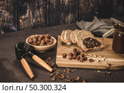 Vegan chocolate spread made of organic almond butter and organic cacao and honey, on dark rustic kitchen counter top. Стоковое фото, агентство Ingram Publishing / Фотобанк Лори