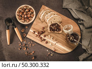 Vegan chocolate spread made of organic almond butter and organic cacao and honey, on dark rustic kitchen counter top. Стоковое фото, агентство Ingram Publishing / Фотобанк Лори