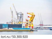 Big Cargo Containers Boat with Goods cargo Stack at the Pier docks port waiting for international sea freight transportation in Rotterdam Port of Netherlands. Стоковое фото, агентство Ingram Publishing / Фотобанк Лори