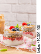 Chia pudding with oat and berries in a glass jar on rustic background. Стоковое фото, агентство Ingram Publishing / Фотобанк Лори
