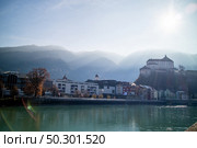 Amazing autumn landscape with Kufstein Fortress and traditional houses on a boardwalk of smooth Inn river on a forefront on a background of clear sunny sky, Kufstein Austria.. Kufstein Fortress beautiful landscape with smooth river on a forefront, Austria. Стоковое фото, агентство Ingram Publishing / Фотобанк Лори