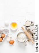 Baking homemade bread on white kitchen worktop with ingredients for cooking, culinary background, copy space, overhead view. Стоковое фото, агентство Ingram Publishing / Фотобанк Лори
