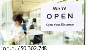 Panoramic Reopening restaurant signage with social distance new normal restaurant with background of asian waiter and waitress prepare restaurant before open. New normal restaurant lifestyle concept. Стоковое фото, агентство Ingram Publishing / Фотобанк Лори
