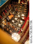 Top view to orchestra pit without musicians in the interior of the Vienna State Opera before starting performance in Vienna, Austria.. Orchestra pit without artists in the interior of the Vienna State Opera auditorium. Стоковое фото, агентство Ingram Publishing / Фотобанк Лори