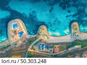Aerial view of beautiful sandy beach, blue sea, restaurants on the promenade, pool, umbrellas, swimming people in clear water, green trees at sunset in summer. Top view of seafront. Tropical landscape. Стоковое фото, агентство Ingram Publishing / Фотобанк Лори