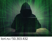 programmer hacker working on front of his laptop writing code  in the middle of night . Стоковое фото, агентство Ingram Publishing / Фотобанк Лори