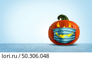 Halloween facial mask as a jack o lantern pumpkin wearing a medical face protection as an autumn symbol for disease control and virus infection and coronavirus or covid-19 safety in a 3D illustration style. Стоковое фото, агентство Ingram Publishing / Фотобанк Лори