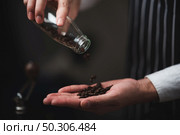barista pouring coffee powder from a coffee grinder to a dripper to make fresh coffee in the cafe. Стоковое фото, агентство Ingram Publishing / Фотобанк Лори