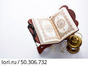High angle opened quran next to candle. Стоковое фото, агентство Ingram Publishing / Фотобанк Лори