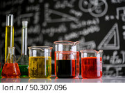 Laboratory glassware with liquids of different color. Стоковое фото, агентство Ingram Publishing / Фотобанк Лори