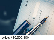 Check Issuing Concept Closeup Photo. Business Check and the Elegant Fountain Pen. Executive Desk. Стоковое фото, агентство Ingram Publishing / Фотобанк Лори