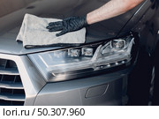 Man in a garage. Worker polish a car. Стоковое фото, агентство Ingram Publishing / Фотобанк Лори