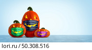 Halloween safety mask as a group of jack o lantern pumpkin wearing a medical face protection as an autumn symbol for disease control and virus infection and coronavirus or covid-19 safety in a 3D illustration style. Стоковое фото, агентство Ingram Publishing / Фотобанк Лори