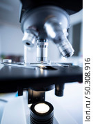 Close-up shot of microscope with metal lens at laboratory, Modern medical laboratory equipment. Стоковое фото, агентство Ingram Publishing / Фотобанк Лори