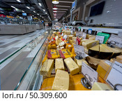 Refrigerator with cheese products from the supermarket "Spar" close-up. Russia. Moscow. 22.06.25. Редакционное фото, фотограф Ярославский Максим / Фотобанк Лори