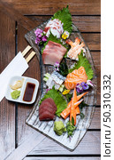 Variety of gourmet Sashimi set japanese freshness cuisine Salmon Tuna Otoro Saba Hamachi Octopus and shrimp meat. Restaurant gastronomy food and drink consumerism concept. Стоковое фото, агентство Ingram Publishing / Фотобанк Лори