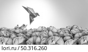 Exit Strategy freedom solution concept as a business plan idea for a contingency plan to leave and prosper elsewhere as a group of crumpled paper with one transforming into an origami bird escaping. Стоковое фото, агентство Ingram Publishing / Фотобанк Лори