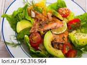 Salad with fried trout, avocado, tomatoes. Стоковое фото, фотограф Яков Филимонов / Фотобанк Лори