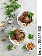 Chocolate and banana fruit ice cream with almond nuts served in bowls, top view. Стоковое фото, агентство Ingram Publishing / Фотобанк Лори