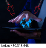 Global conflict visualized through technology with missile illustrations over a digital globe. Стоковое фото, фотограф Климов Денис / Фотобанк Лори