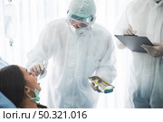scientist doctor ppe suit and goggles and mask to corona virus covid-19 disease protection, working about health pandemic medicine in quarantine hospital laboratory with outbreak prevention. Стоковое фото, агентство Ingram Publishing / Фотобанк Лори