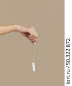 hand holding tampon front view. Стоковое фото, агентство Ingram Publishing / Фотобанк Лори