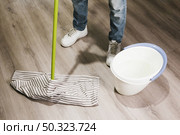 close up man mopping floor. Стоковое фото, агентство Ingram Publishing / Фотобанк Лори