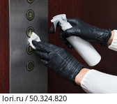 hands with gloves disinfecting elevator buttons. Стоковое фото, агентство Ingram Publishing / Фотобанк Лори