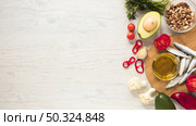 healthy vegetables dryfruits oil raw fish wooden table. Стоковое фото, агентство Ingram Publishing / Фотобанк Лори