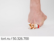 person fist crushing packet cigarettes white background. Resolution and high quality beautiful photo. person fist crushing packet cigarettes white background. High quality beautiful photo concept. Стоковое фото, агентство Ingram Publishing / Фотобанк Лори