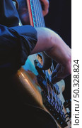 Playing a five-string bass guitar close-up. Hands professionally picking and pulling strings. The deck of the bass guitar is made of wood. Slow motion. Стоковое видео, видеограф Воловодов Владимир / Фотобанк Лори
