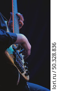 A close-up of a musician's hands skillfully playing a bass guitar. The strings vibrate under his fingers, blue lighting illuminates the bassist. Jazz band on stage. Стоковое видео, видеограф Воловодов Владимир / Фотобанк Лори